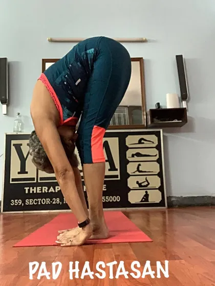 A clear view of the hand-to-foot connection in Padahastasana. I teach the proper alignment to get the most benefit from this deep stretch.