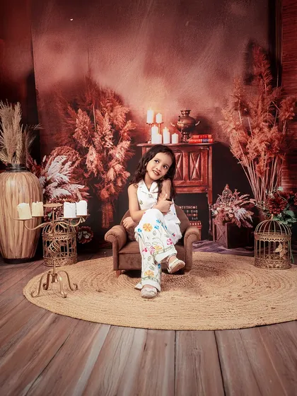 A moment of quiet grace. This solo portrait of the older sister shows her poised and gentle personality during a sibling session.