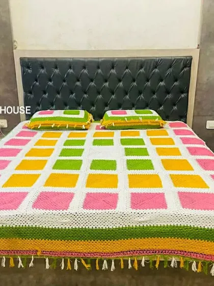 A full view of the vibrant bedspread, showcasing the detailed tassel work along the edges. I can add custom borders like tassels or lace to any blanket or throw.