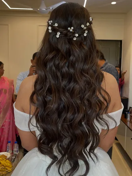 A beautiful view of the romantic hairstyle for this Christian bride. The soft waves are braided and adorned with delicate baby's breath, creating a truly angelic look.