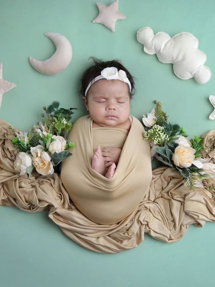 A dreamy sky full of stars, clouds, and a crescent moon. This overhead shot combines floral elements with celestial props for a unique and beautiful composition.