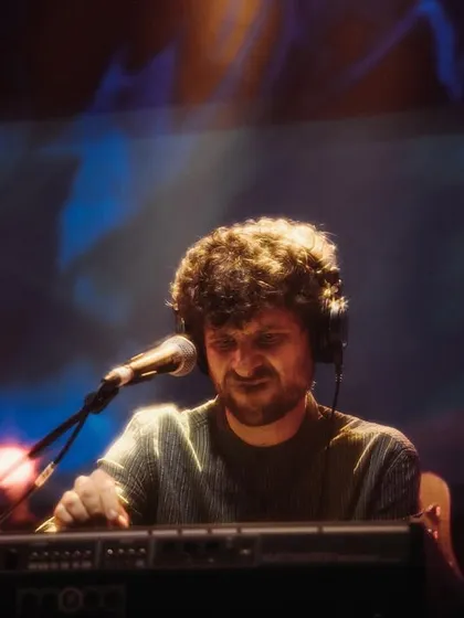 A duplicate of image 138, Michael League, smiling and enjoying the music during our 'Vari' album release concert. His love for music is infectious and spreads to everyone on stage and in the audience.