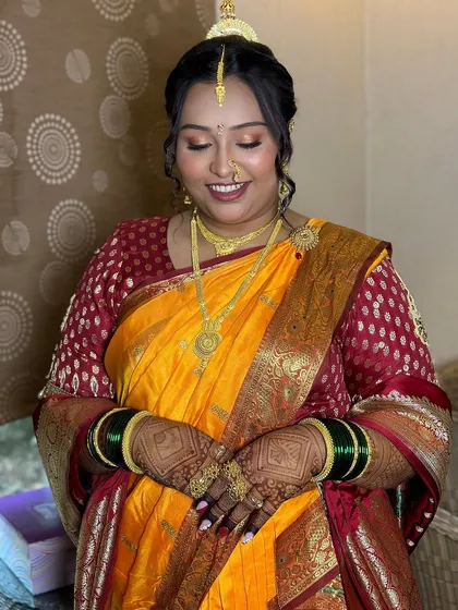 A radiant bride ready for her wedding rituals, showcasing a classic Maharashtrian look with a beautiful yellow saree.