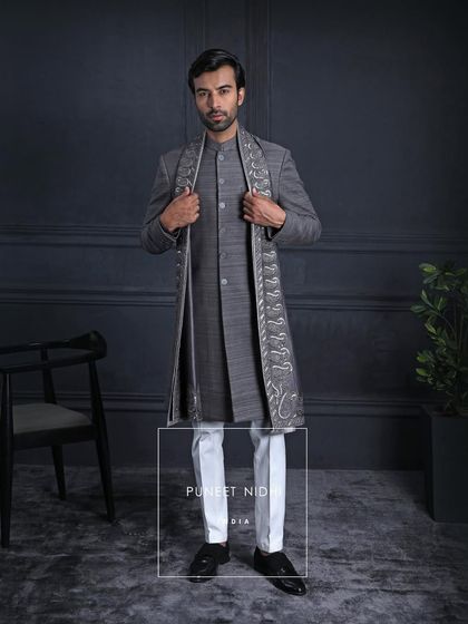 Wrapped in the quiet strength of charcoal grey, this Matka silk ensemble is a crown of heritage. The paisley stole is a royal whisper of India’s craft, draped for the modern maharaja.