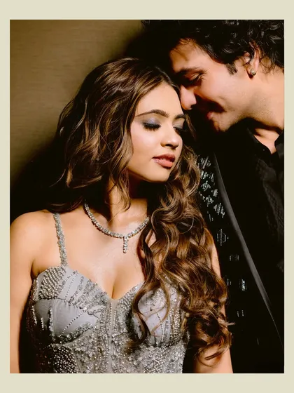 An intimate close-up of the couple, his face close to hers, capturing a moment of quiet connection and romance.