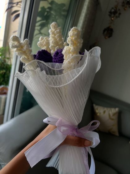 A hand-held view of my popular purple and white bouquet. Each flower is carefully crocheted and arranged to create a full and beautiful display that you can hold onto forever.