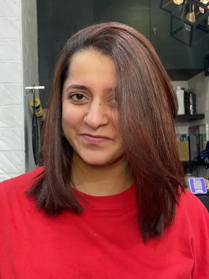 A beautiful, rich auburn color on a medium-length cut. This is a great example of a warm, vibrant global color.