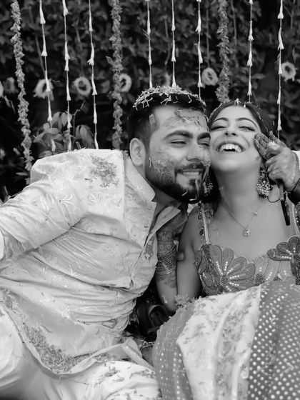 Pure, unadulterated joy during a Haldi ceremony. This black and white photo freezes a moment of absolute laughter and fun, a memory that will be cherished forever.