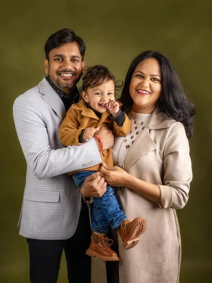 A candid family laugh. This portrait captures a genuine moment of happiness between parents and their child.