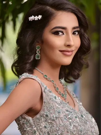 A smiling shot that shows how the makeup looks natural and not heavy, even with full glam.