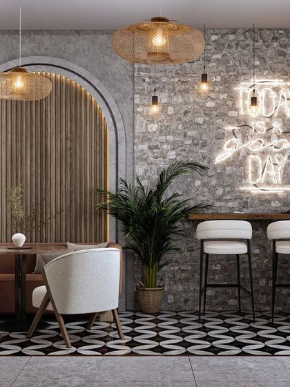 A cozy corner with a bar-style seating area against an exposed brick wall, featuring a neon sign that reads "Today is a good day." It creates a perfect photo opportunity for customers.