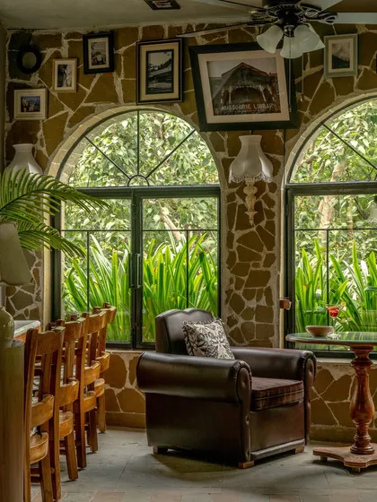 For Echoes Café, we transformed a challenging layout into a series of intimate, soulful corners. This nook, with its rubble-clad walls, arched window, and plush armchair, feels collected over time. It is a space designed not just for a meal, but for a moment of quiet reflection.