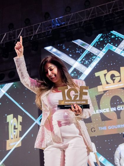 A moment of pure joy. Our co-founder celebrates on stage after winning the Gold award for 'Excellence in Global Dessert', a testament to our team's hard work and creativity.