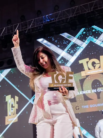 A moment of pure joy. Our co-founder celebrates on stage after winning the Gold award for 'Excellence in Global Dessert', a testament to our team's hard work and creativity.
