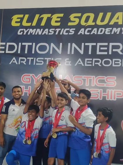 The joy of a team victory. Our gymnasts and coaches celebrating with the championship trophy at our 1st Edition Inter-Club competition.
