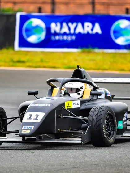 An F4 car speeds down the track at the Indian Racing Festival. We manage all track-side branding, ensuring high visibility for sponsors like Nayara Energy.