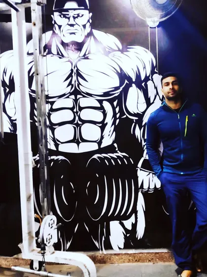 Standing in front of our motivational wall art. The energy at Loordz Gym is all about inspiring you to push your limits.