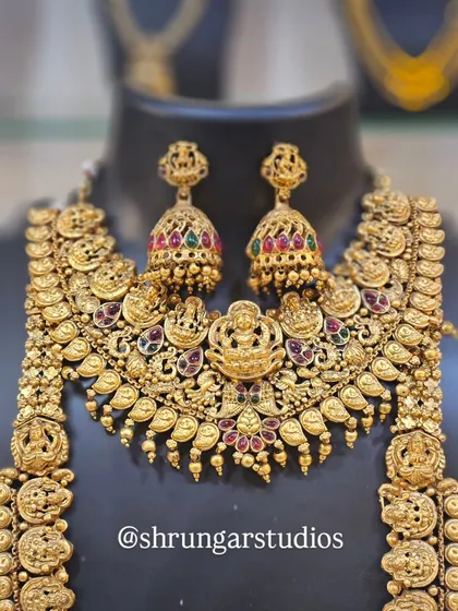 This is a full, opulent temple jewellery set with intricate carvings of deities, perfect for a traditional wedding ceremony.