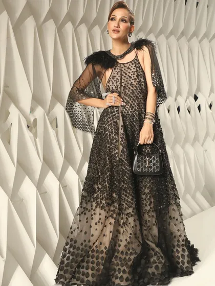 This full-length shot shows how the entire look comes together, with the dramatic makeup complementing the exquisite black gown.