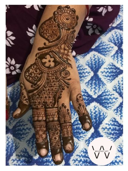 A close-up of a single hand with an Arabic design.