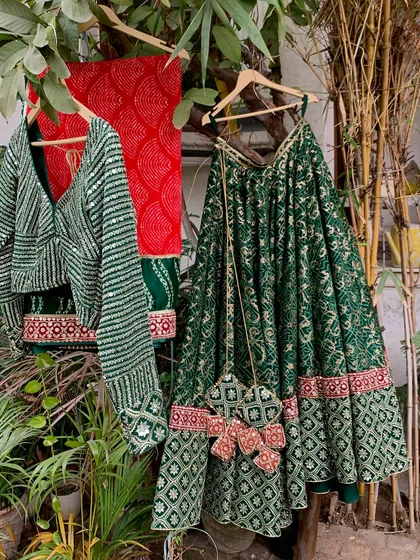 The complete green bandhani lehenga set hanging in our garden. The colors look so rich in the natural light.
