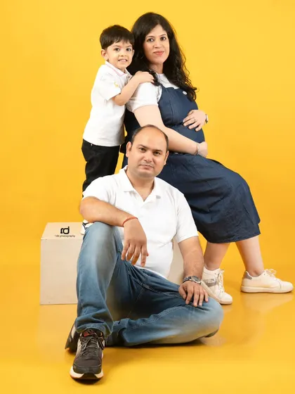 A classic family pose during a maternity session. The older brother gives his mom a sweet hug, showing the loving bond that is about to be shared with a new baby.