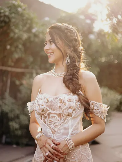 A beautiful portrait of the bride at her Carnival event. The combination of the intricate braid, glowing skin, and delicate dress creates a truly unforgettable look.