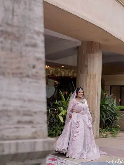 A candid shot of the bride walking, her beautiful lehenga flowing around her.
