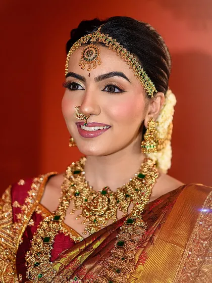A smiling bridal portrait that captures the joy of the occasion. The warm, festive lighting and traditional attire make this a perfect shot for a Diwali-themed wedding look.