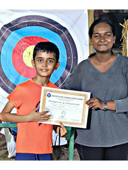 Another happy graduate from the May 2023 archery summer camp. His smile says it all.