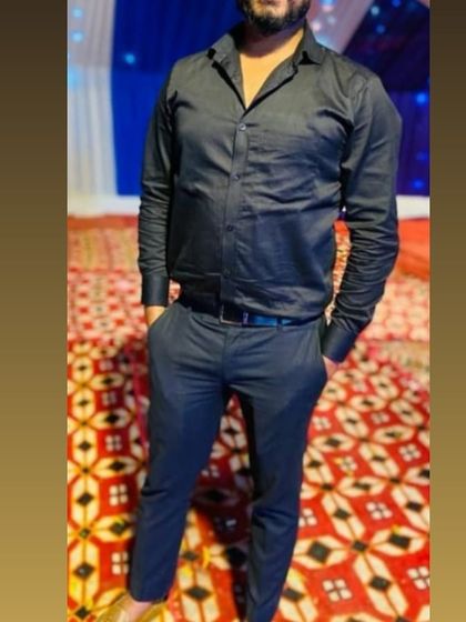 A client dressed in a black formal shirt and trousers I tailored for him. A monochromatic look like this is always sharp and stylish for an evening event.