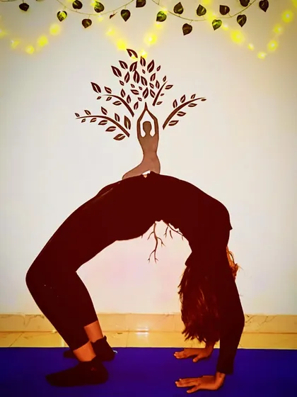 The Wheel Pose (Chakrasana) is a powerful heart-opener that strengthens the spine, arms, and legs. This image captures the full expression of the pose, showcasing the flexibility and strength that a consistent practice can build.