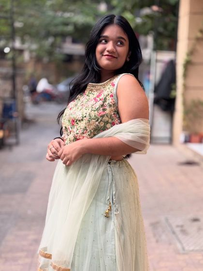 A lovely candid shot of a model in the mint green lehenga. It’s a versatile outfit that can be dressed up or down for any occasion.