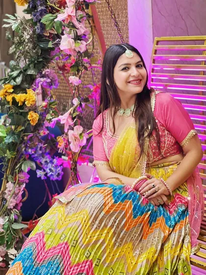 A candid moment in my multi-colored zig-zag pattern lehenga, paired with a simple pink blouse and light jewelry for a balanced festive look.