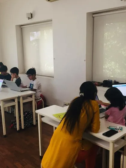A glimpse into one of our in-person summer coding classes in Delhi. Here, an instructor provides personalized guidance to a young student, reflecting our hands-on, supportive teaching philosophy.