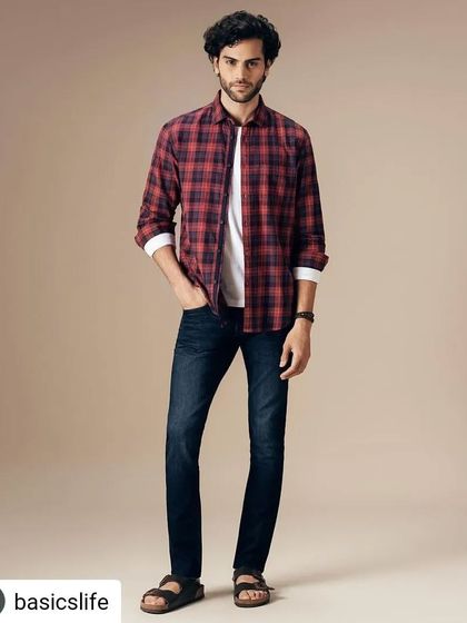 Styling a classic casual look for Basics Life. A red plaid shirt layered over a white t-shirt and paired with dark wash denim is a versatile and essential combination for any man's wardrobe.