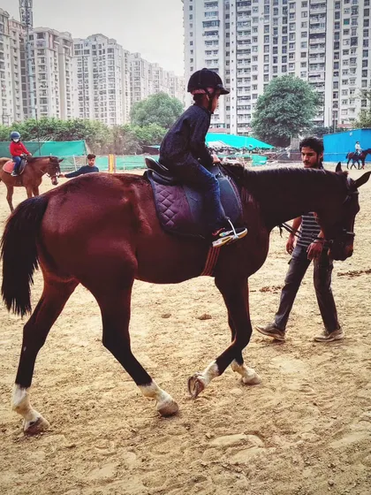 A young rider learns the basics of balance and posture during a led ride. Our trainers provide constant support and guidance throughout the session.