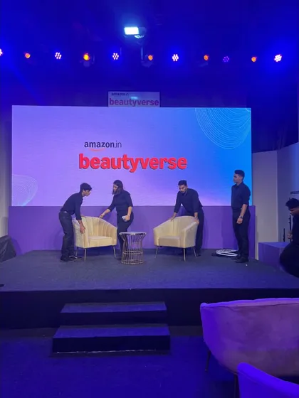 Our crew setting up the stage for a panel discussion at Amazon Beautyverse. We ensure every detail, from chair placement to branding, is perfect before the artists arrive.