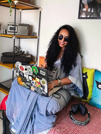 Taking a moment at home, but the music is never far away. My laptop, covered in stickers from bass music culture, is where I prep my sets and work on new ideas, always thinking about the next track.