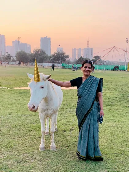 Even unicorns make an appearance at our parties. A guest poses with one of our horses dressed up for a magical birthday theme.