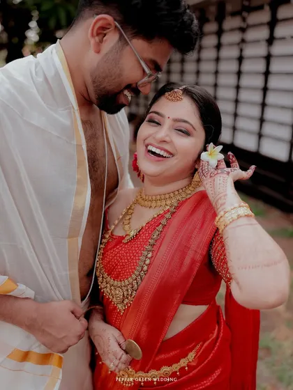 A candid moment of pure joy, as the bride laughs while the groom whispers in her ear.