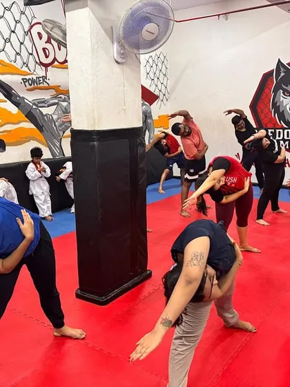 A different angle of our group during a fusion fitness warm-up. Everyone, regardless of their fitness level, participates together, creating a supportive and motivating environment to start the workout.