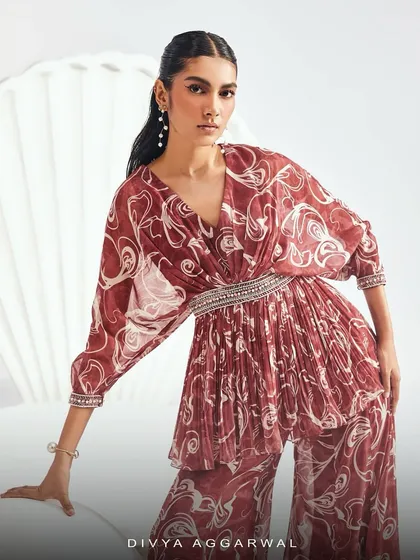 A close-up of the ELIZA Sharara Set, focusing on the pleated kurta with its embellished waistband and cuffs.