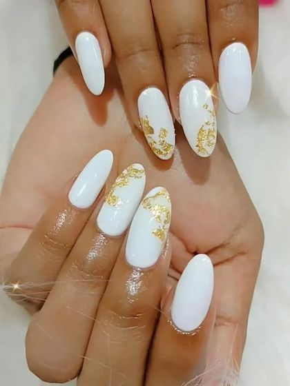 Another view of the white and gold foil nail design.