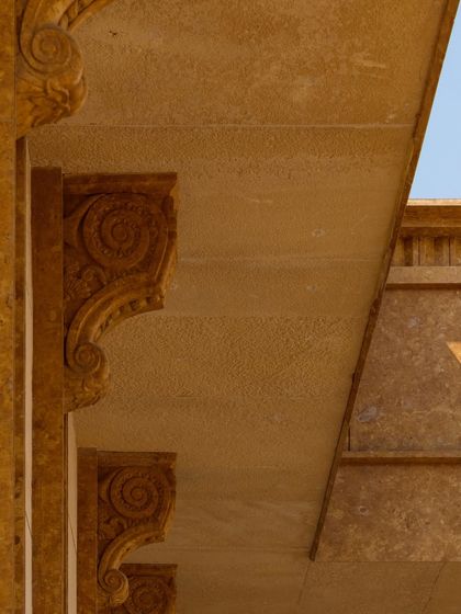 The terrace projections of Stone Print Villa are layered to exaggerate scale, with cast mouldings and scalloped corbels that play with shadow and surprise.