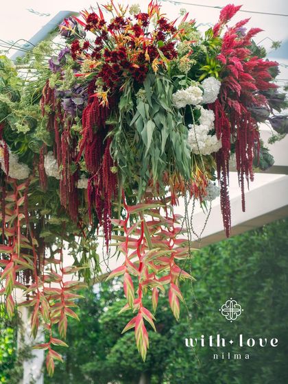 A hanging floral installation from the 'Garden of Gaia' baby shower, adding a touch of drama and beauty from above.