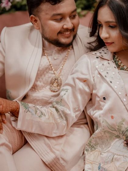 A tender moment between the couple, with their hands intertwined, showcasing their connection.