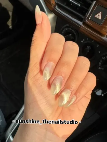 A client photo of her cat eye nails shining in the sun.