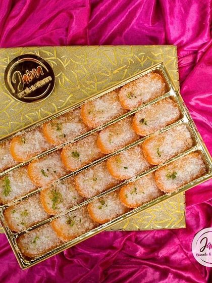 A premium mithai box featuring our special orange and coconut barfis. The elegant gold packaging makes it a perfect gift for sharing joy with your loved ones during the festive season.