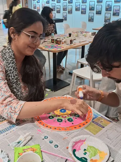 Teamwork makes the dream work. Colleagues help each other with their Lippan art projects during a creative corporate event we hosted.